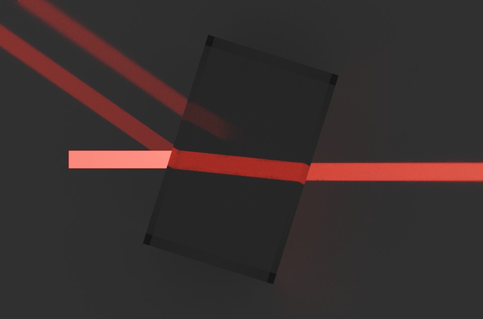 A glass block is lit by a large beam, refraction and internal reflection are visible.
